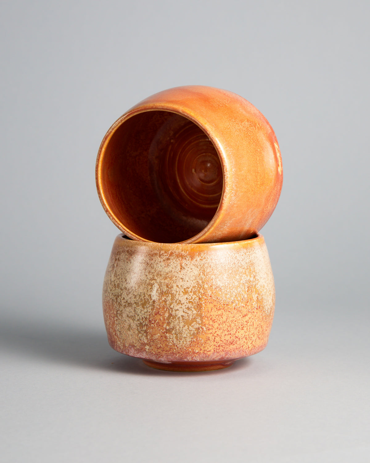 WINDY CUP 'CORAL', two cups stacked, showing the glazed interior